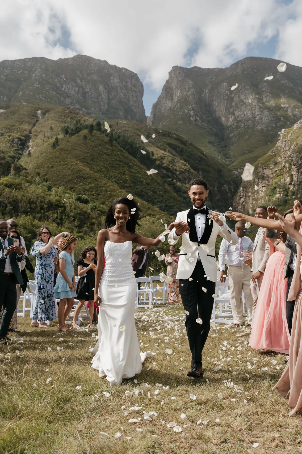 Newlyweds showered with confetti as they walk back up the aisle